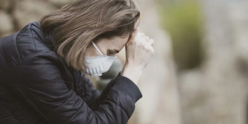 WOMAN PRAYING WITH MASK ON