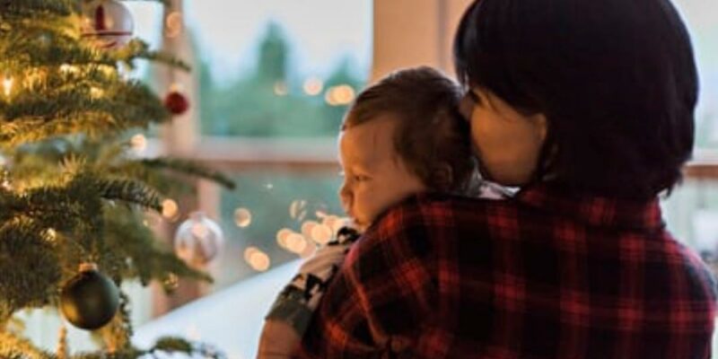 MOM BABY LOOKING AT CHRISTMAS TREE