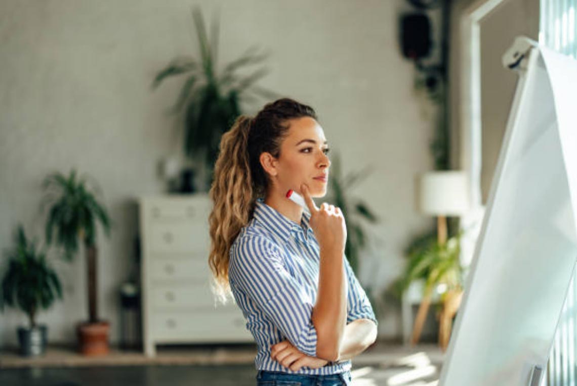 Woman staring at a white board